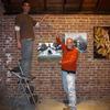 Doug and Tedrowe show off their art hanging skills.